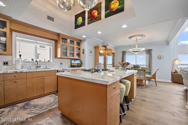 2943 S Ponte Vedra Blvd, Ponte Vedra Beach, FL 32082 - kitchen featuring a sink, decorative backsplash, crown molding, a chandelier, and light wood-style floors