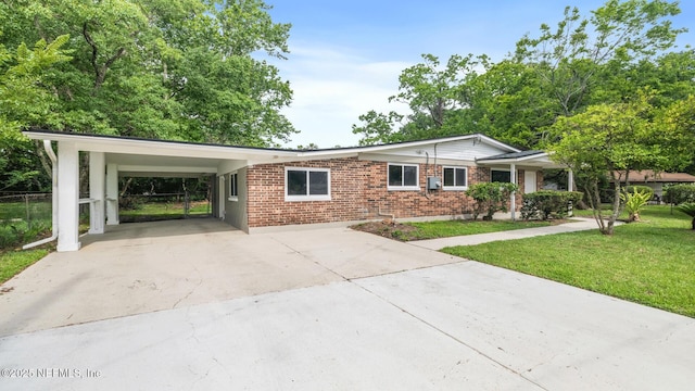 9430 Norfolk Blvd, Jacksonville, FL 32208 - single story home with concrete driveway, brick siding, and an attached carport