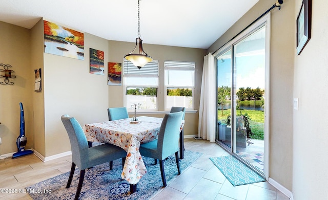 12237 Woodview Dr, Jacksonville, FL 32246 - dining space with a water view, baseboards, and light tile patterned flooring