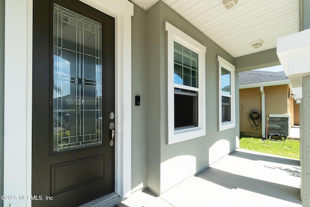 12237 Woodview Dr, Jacksonville, FL 32246 - property entrance with covered porch and stucco siding