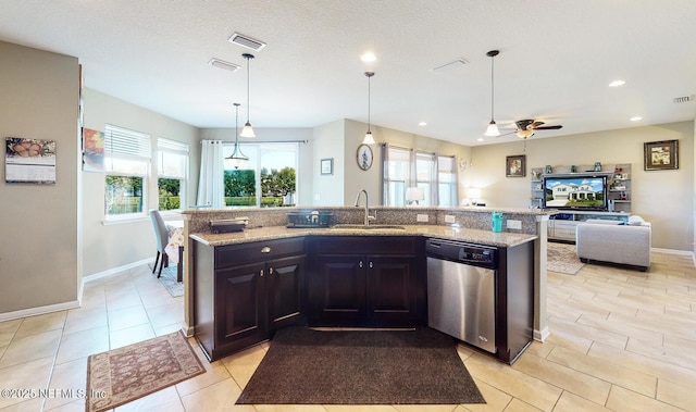 12237 Woodview Dr, Jacksonville, FL 32246 - kitchen with stainless steel dishwasher, a sink, open floor plan, light stone countertops, and recessed lighting