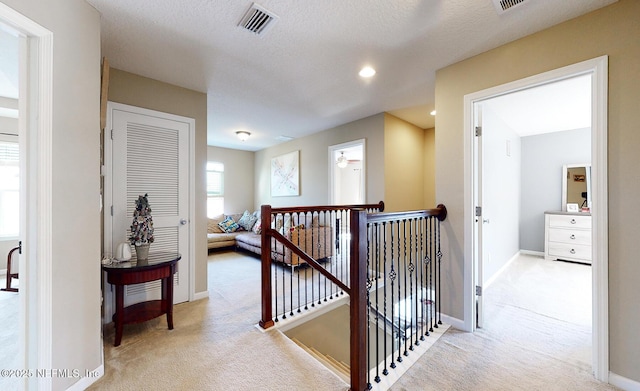 12237 Woodview Dr, Jacksonville, FL 32246 - hallway featuring an upstairs landing, carpet flooring, baseboards, and a textured ceiling