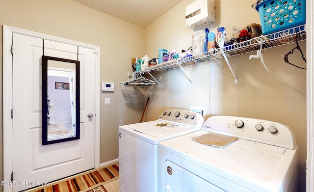 12237 Woodview Dr, Jacksonville, FL 32246 - laundry room featuring independent washer and dryer, a textured ceiling, and baseboards