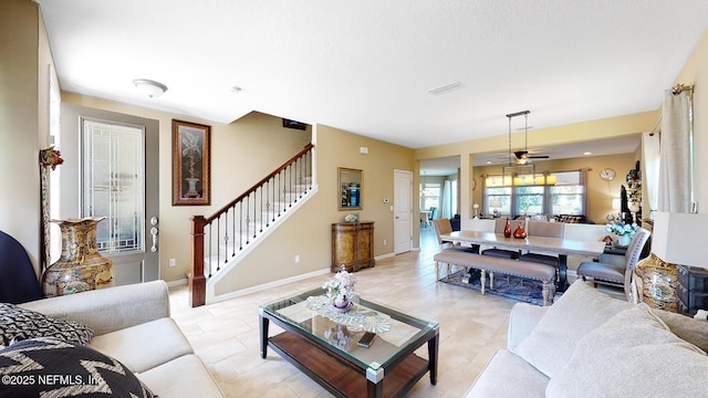 12237 Woodview Dr, Jacksonville, FL 32246 - living area featuring stairs, a ceiling fan, light tile patterned flooring, and baseboards