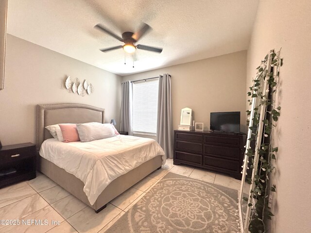 13703 Richmond Park Dr N Unit 2902, Jacksonville, FL 32224 - bedroom featuring ceiling fan, light tile patterned floors, and a textured ceiling