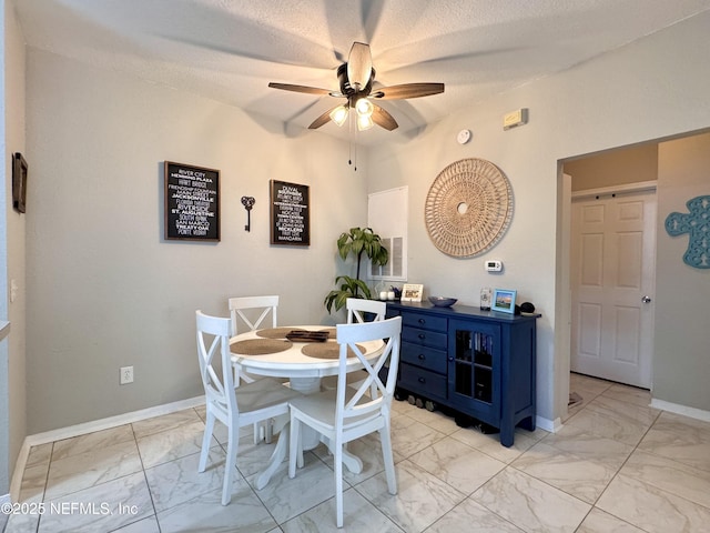 13703 Richmond Park Dr N Unit 2902, Jacksonville, FL 32224 - dining room with light marble finish flooring, a ceiling fan, baseboards, and a textured ceiling