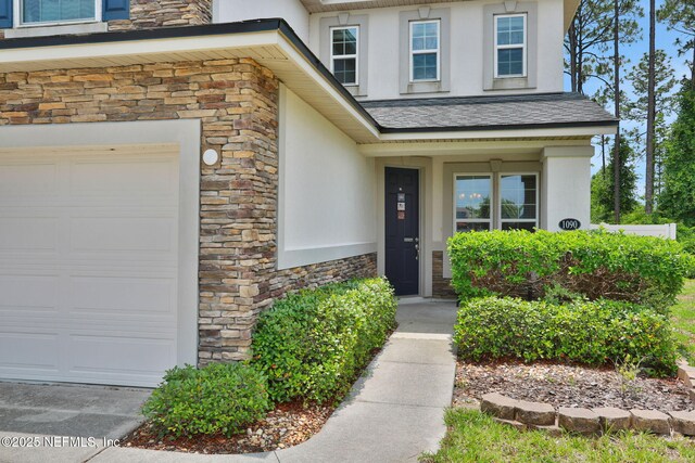 1090 Wetland Ridge Cir, Middleburg, FL 32068 - view of exterior entry featuring stone siding and stucco siding
