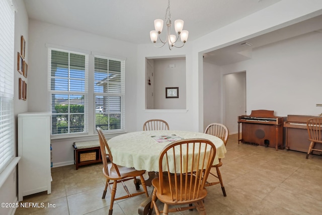 1090 Wetland Ridge Cir, Middleburg, FL 32068 - dining area with a chandelier, light tile patterned flooring, and baseboards