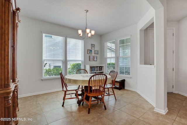 1090 Wetland Ridge Cir, Middleburg, FL 32068 - dining room featuring a chandelier, light tile patterned floors, and baseboards