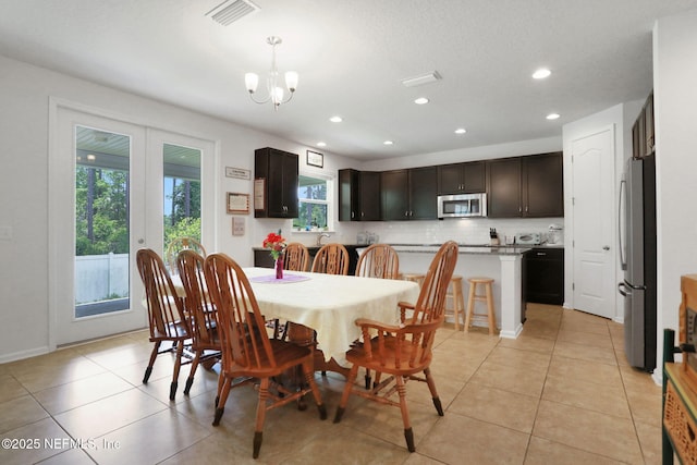 1090 Wetland Ridge Cir, Middleburg, FL 32068 - dining room with a chandelier, light tile patterned floors, and recessed lighting