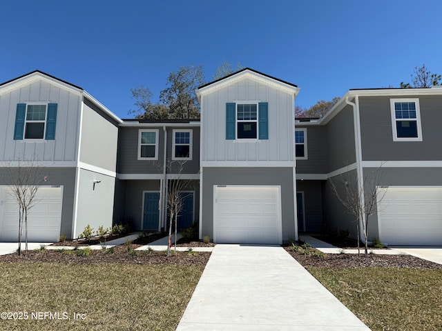 13525 Ute Pl, Jacksonville, FL 32218 - view of front of property with board and batten siding, an attached garage, and concrete driveway