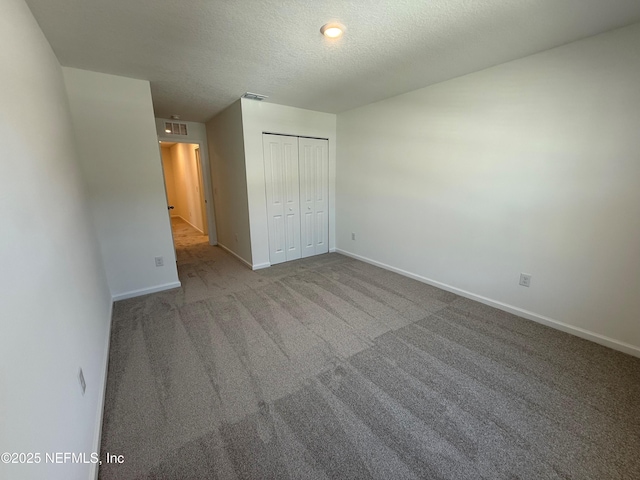 13525 Ute Pl, Jacksonville, FL 32218 - unfurnished bedroom with baseboards, carpet flooring, a closet, and a textured ceiling