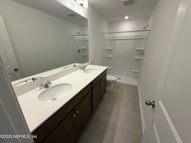 13525 Ute Pl, Jacksonville, FL 32218 - bathroom with a shower, double vanity, toilet, and tile patterned flooring