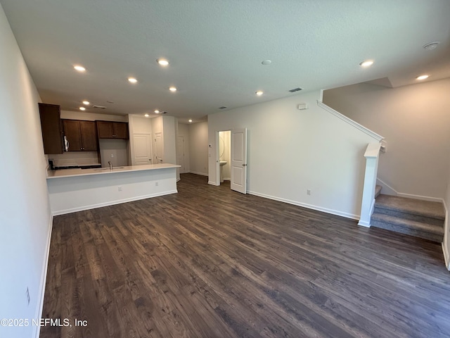 13525 Ute Pl, Jacksonville, FL 32218 - unfurnished living room with recessed lighting, dark wood finished floors, a sink, baseboards, and stairway