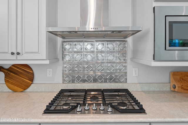 220 Hoptree Pl, Saint Johns, FL 32259 - kitchen view of wall chimney range hood, stainless steel appliances, white cabinetry, and backsplash