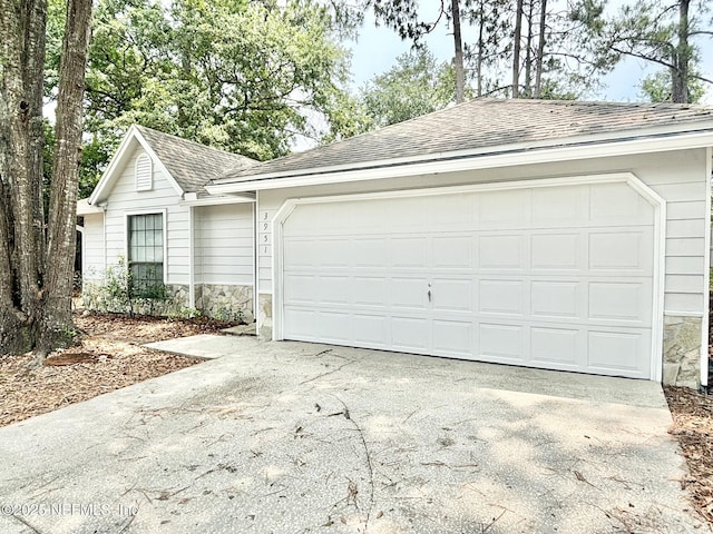 3951 Hunters Lake Cir W, Jacksonville, FL 32210 - view of front facade with stone siding, roof with shingles, concrete driveway, and an attached garage