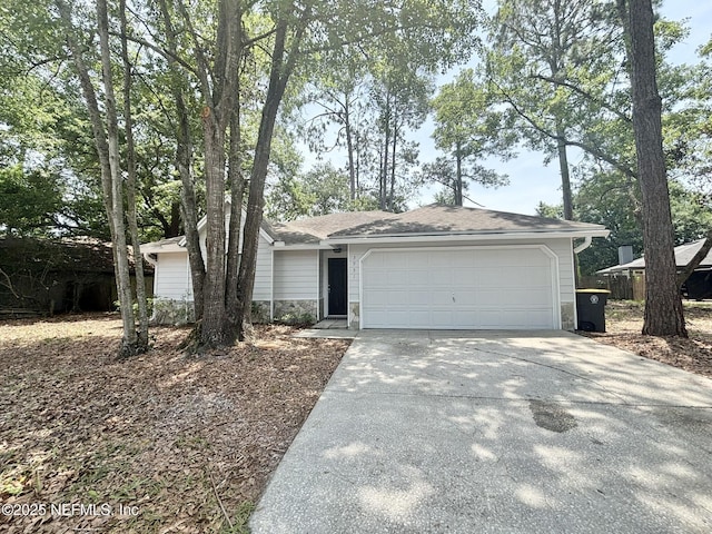 3951 Hunters Lake Cir W, Jacksonville, FL 32210 - view of front of house with concrete driveway, a garage, and stone siding