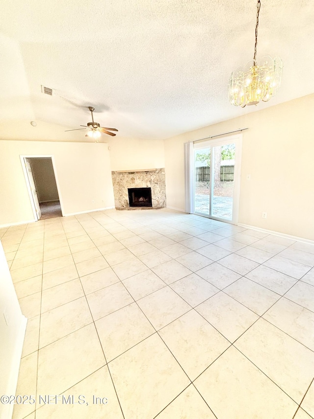 3951 Hunters Lake Cir W, Jacksonville, FL 32210 - unfurnished living room featuring a chandelier, a textured ceiling, a fireplace, light tile patterned floors, and ceiling fan