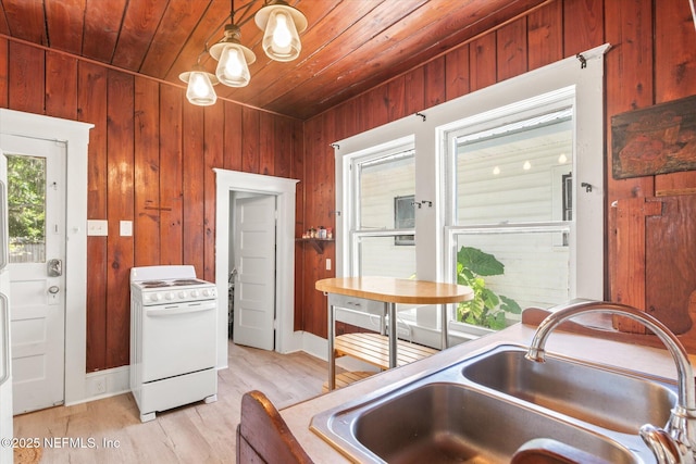 27 Grant St, Saint Augustine, FL 32084 - kitchen with white stove, a sink, wood walls, wooden ceiling, and light wood-type flooring