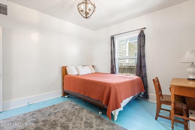 27 Grant St, Saint Augustine, FL 32084 - bedroom featuring baseboards and a chandelier