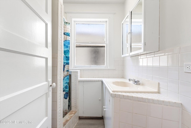 27 Grant St, Saint Augustine, FL 32084 - full bath with vanity, a shower with shower curtain, and decorative backsplash