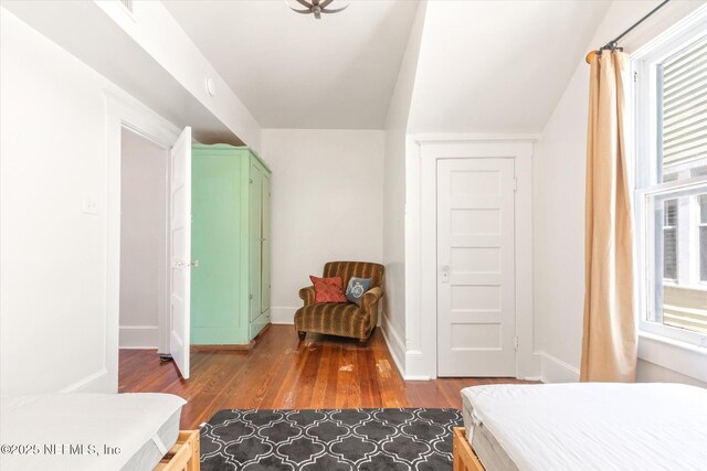 27 Grant St, Saint Augustine, FL 32084 - bedroom with dark wood-type flooring, multiple windows, and baseboards