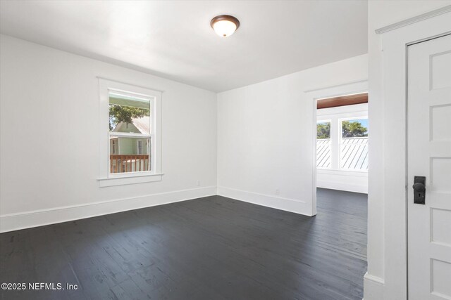 27 Grant St, Saint Augustine, FL 32084 - unfurnished room featuring dark wood-style floors and baseboards