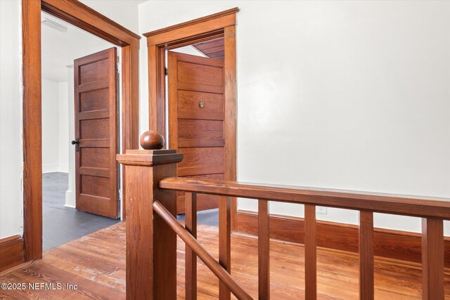 27 Grant St, Saint Augustine, FL 32084 - corridor with wood finished floors, an upstairs landing, and baseboards