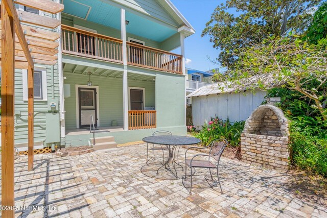 27 Grant St, Saint Augustine, FL 32084 - covered porch with a balcony and a patio
