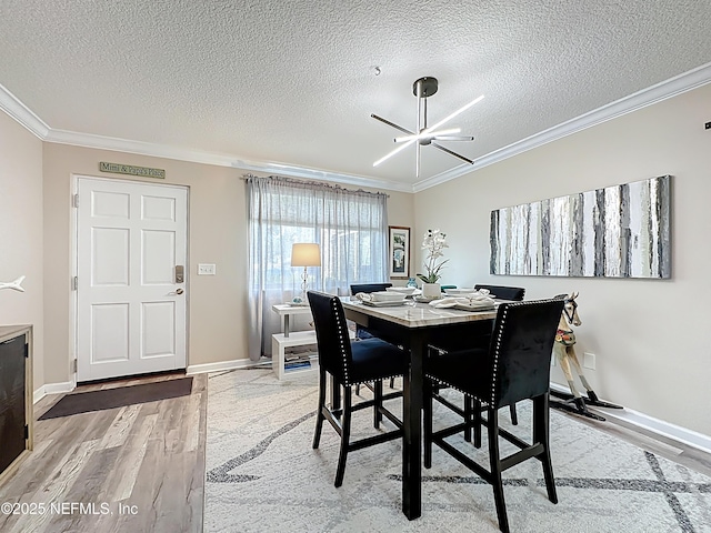 5375 Ortega Farms Blvd Unit 1011, Jacksonville, FL 32210 - dining space featuring ornamental molding, wood finished floors, a textured ceiling, and baseboards
