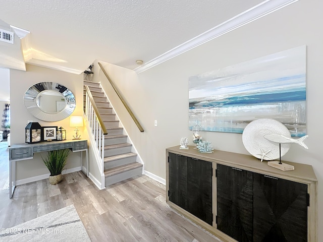 5375 Ortega Farms Blvd Unit 1011, Jacksonville, FL 32210 - staircase featuring crown molding, wood finished floors, a textured ceiling, and baseboards