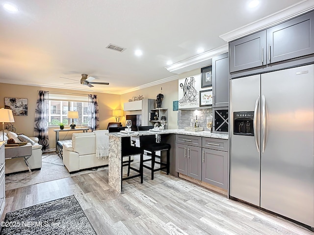 5375 Ortega Farms Blvd Unit 1011, Jacksonville, FL 32210 - kitchen featuring stainless steel fridge, crown molding, a peninsula, open floor plan, and gray cabinetry