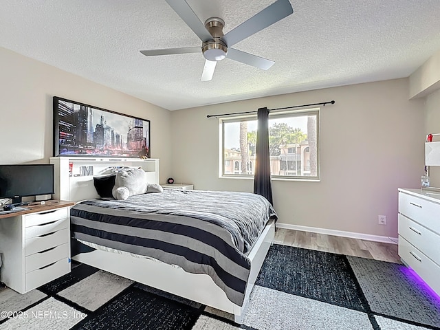 5375 Ortega Farms Blvd Unit 1011, Jacksonville, FL 32210 - bedroom featuring a textured ceiling, wood finished floors, a ceiling fan, and baseboards