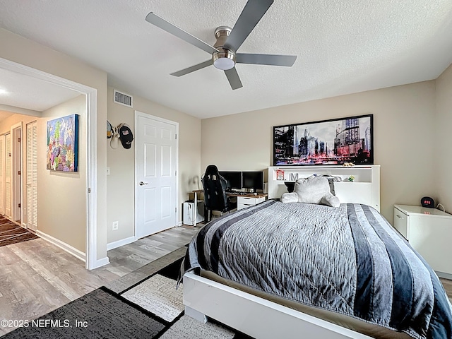 5375 Ortega Farms Blvd Unit 1011, Jacksonville, FL 32210 - bedroom with wood finished floors, a ceiling fan, baseboards, and a textured ceiling