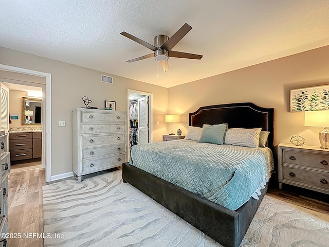 5375 Ortega Farms Blvd Unit 1011, Jacksonville, FL 32210 - bedroom featuring light wood finished floors, a closet, a walk in closet, and a ceiling fan