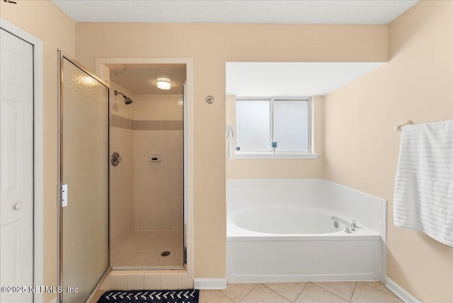 3910 Selig Ct, Middleburg, FL 32068 - bathroom with tile patterned floors, a bath, a stall shower, and baseboards