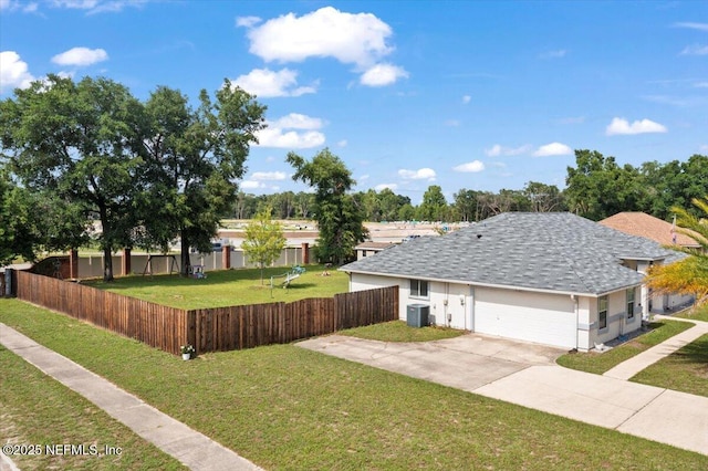 3910 Selig Ct, Middleburg, FL 32068 - view of front facade with central AC unit, driveway, a shingled roof, and an attached garage