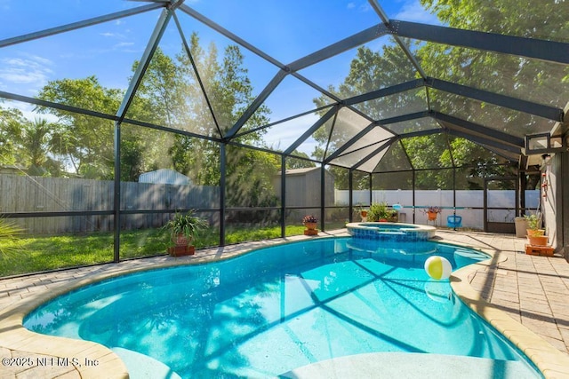 1133 Gunka Rd, Jacksonville, FL 32216 - view of swimming pool featuring a fenced backyard, a pool with connected hot tub, a patio area, and a lanai