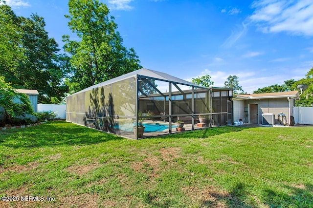 1133 Gunka Rd, Jacksonville, FL 32216 - rear view of house featuring central air condition unit and glass enclosure