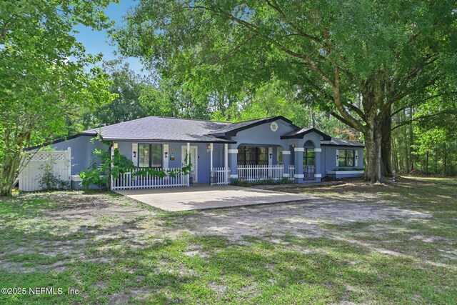 9620 Baylor Ave, Hastings, FL 32145 - ranch-style home with a porch and stucco siding