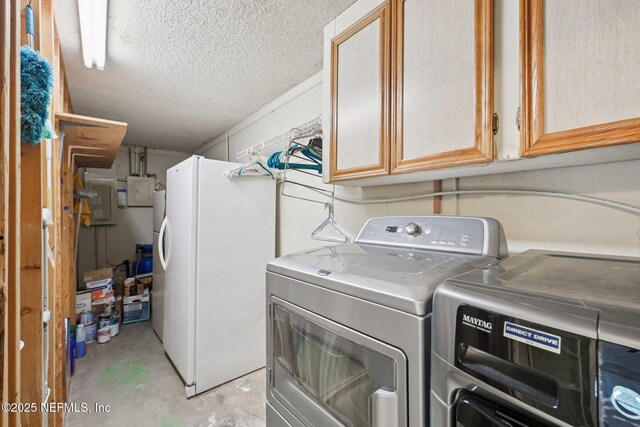 9620 Baylor Ave, Hastings, FL 32145 - laundry area with washer and clothes dryer, cabinet space, a textured ceiling, and concrete block wall