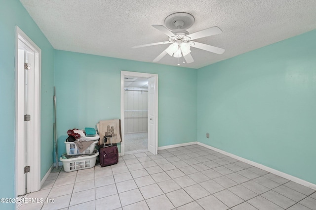 9620 Baylor Ave, Hastings, FL 32145 - spare room with a textured ceiling, ceiling fan, baseboards, and light tile patterned flooring