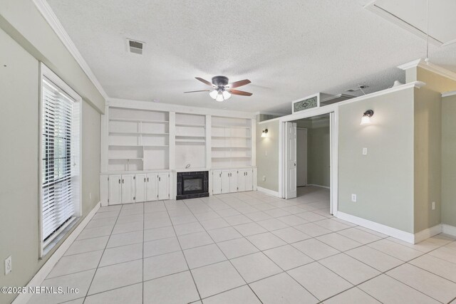 9620 Baylor Ave, Hastings, FL 32145 - unfurnished living room featuring ceiling fan, crown molding, a tile fireplace, a textured ceiling, and light tile patterned floors