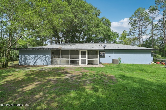 9620 Baylor Ave, Hastings, FL 32145 - rear view of house with a sunroom, central air condition unit, a lawn, and stucco siding