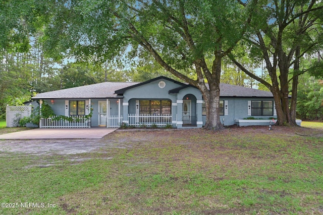 9620 Baylor Ave, Hastings, FL 32145 - ranch-style house featuring stucco siding and covered porch