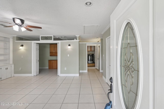 9620 Baylor Ave, Hastings, FL 32145 - entrance foyer featuring light tile patterned floors, a textured ceiling, ceiling fan, washer / dryer, and crown molding