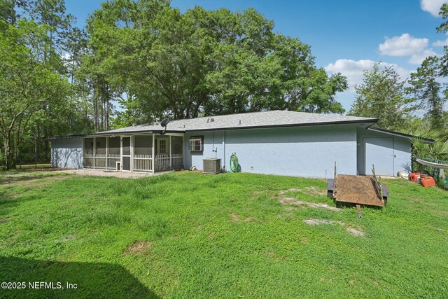 9620 Baylor Ave, Hastings, FL 32145 - rear view of property featuring a sunroom, stucco siding, a lawn, and central air condition unit