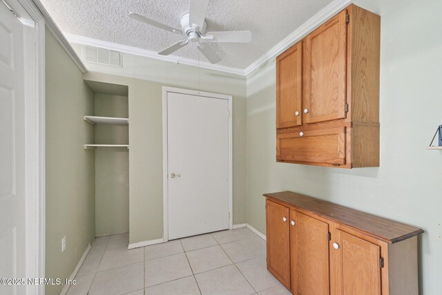 9620 Baylor Ave, Hastings, FL 32145 - interior space featuring a textured ceiling, ornamental molding, light tile patterned flooring, a ceiling fan, and baseboards