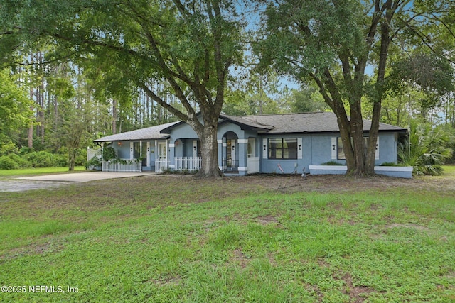 9620 Baylor Ave, Hastings, FL 32145 - single story home featuring stucco siding, a front lawn, and a porch