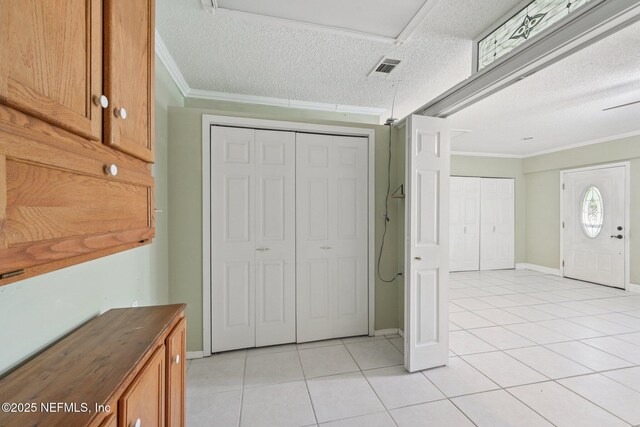 9620 Baylor Ave, Hastings, FL 32145 - foyer with crown molding, a textured ceiling, light tile patterned floors, and baseboards